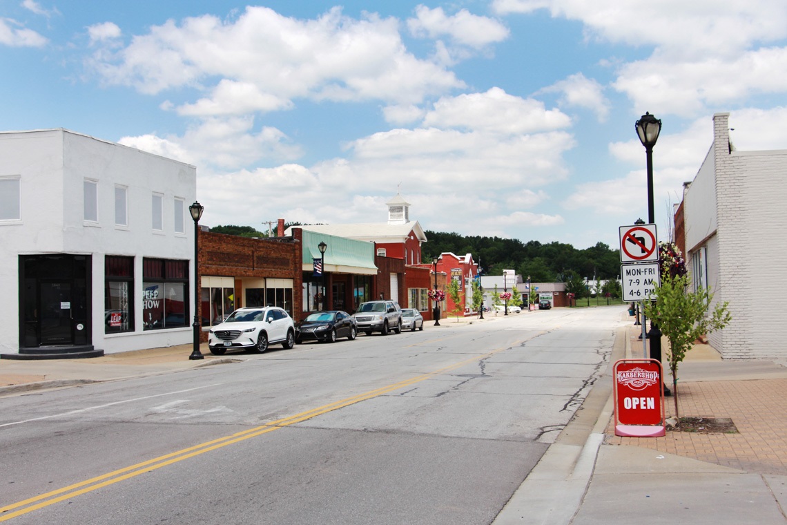 a street view of downtown merriam with buildings on the left and right.