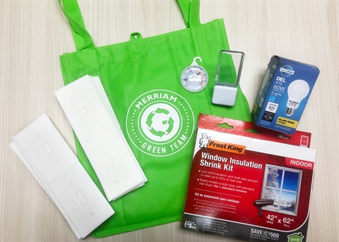 An energy kit: green reusable bag with kit items on top of it.