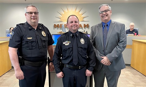 Capt. Waters is flanked by Merriam Police Chief Darren McLaughlin and Mayor Bob Pape. McLaughlin and Waters are in full police uniform.
