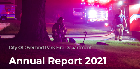 PD digital cover of annual report shows a fireman next to a tree at night. He is on his knees. A fire truck with lights on is to his right with another firefighter walking next to the truck.