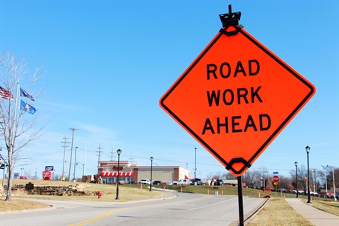 Road Work Ahead sign on street