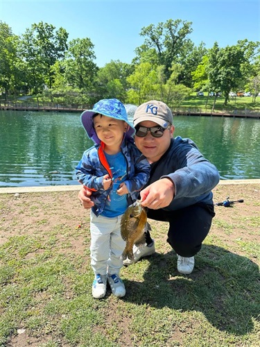 A man and little boy with a fish