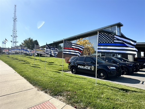 Flags representing different first responders fly at the Merriam Police Department 