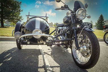 A classic motorcycle in black with a bucket seat.
