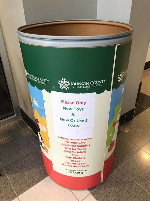 A Johnson County Christmas Bureau barrel sits empty in the Merriam City Hall lobby.