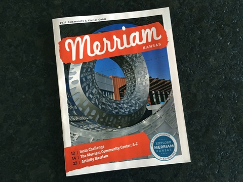 Cover of the 2021 Visitor Guide. Close up image of Bask (steel and words) sculpture with the title Merriam Kansas in white letters with red background.