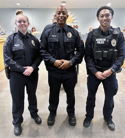 Two men and one woman pose for a photo in their new police gear at a Merriam City Council meeting.
